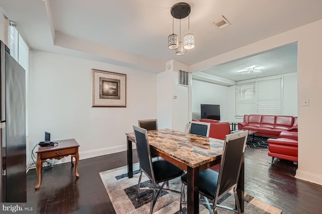 dining room featuring baseboards, visible vents, and dark wood-style flooring