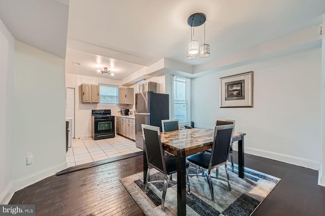 dining room featuring baseboards and light wood-style floors