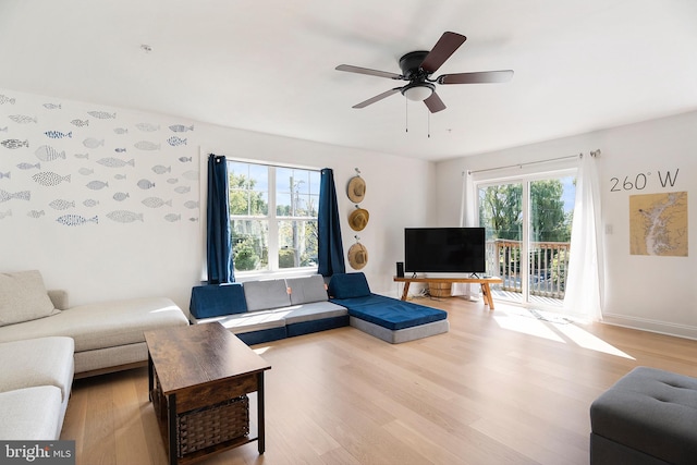 living room featuring plenty of natural light, light hardwood / wood-style floors, and ceiling fan