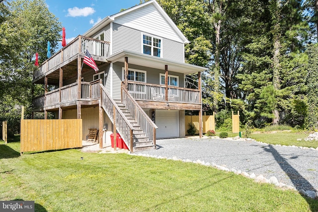 rear view of property with a yard and a garage