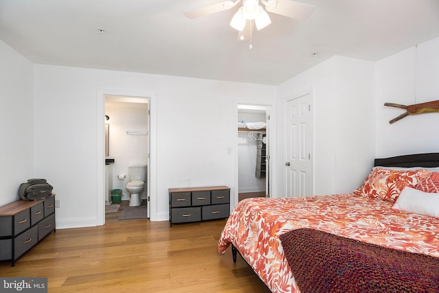 bedroom with a closet, ceiling fan, hardwood / wood-style flooring, a spacious closet, and ensuite bathroom