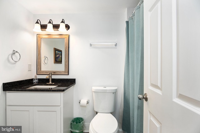 bathroom featuring toilet and vanity