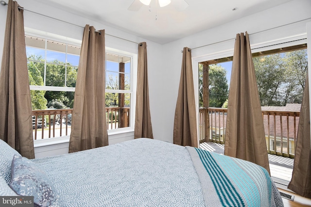 bedroom with multiple windows and ceiling fan