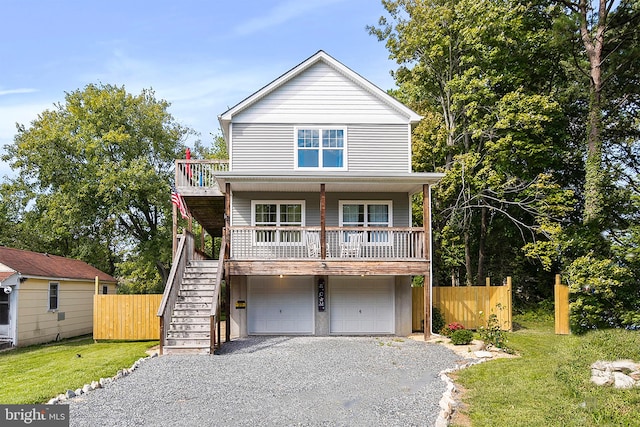 view of front of property with a front lawn, a porch, and a garage