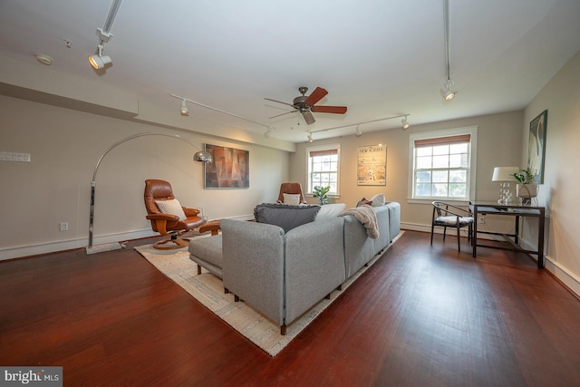 living room with dark hardwood / wood-style flooring, ceiling fan, and rail lighting