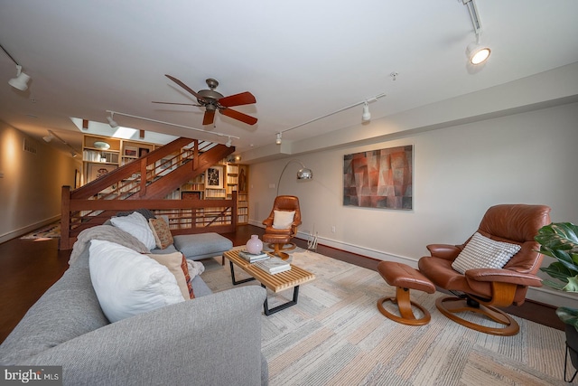 living room with hardwood / wood-style flooring, a baseboard radiator, ceiling fan, and track lighting