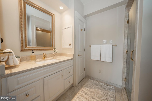 bathroom with walk in shower, tile floors, and vanity