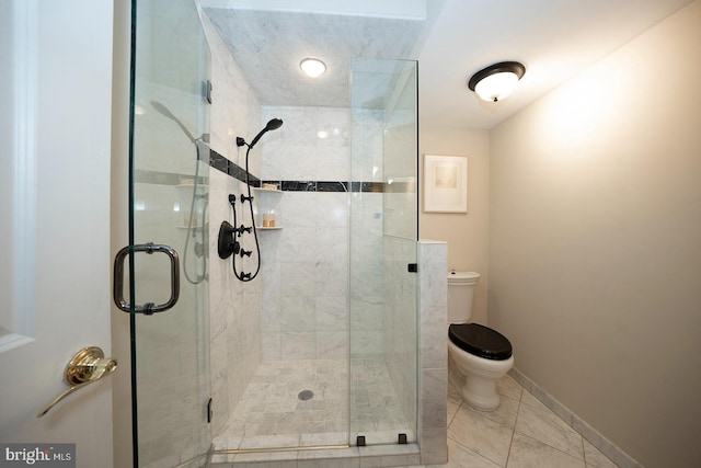 bathroom with a shower with shower door, toilet, and tile flooring