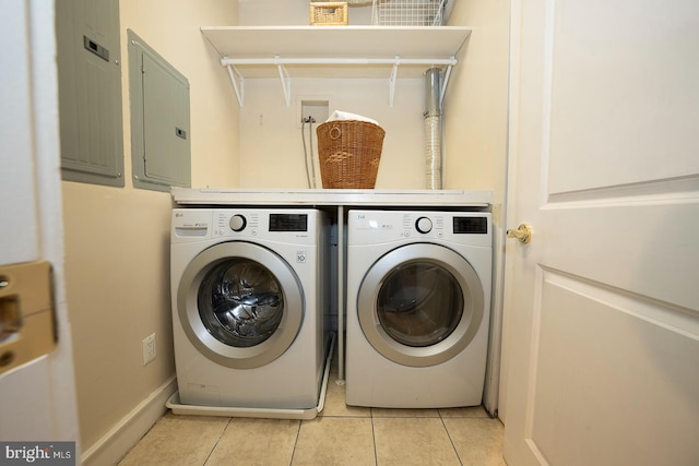 laundry area featuring separate washer and dryer and light tile floors