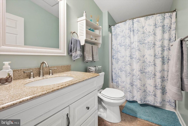 bathroom with toilet, tile flooring, and vanity