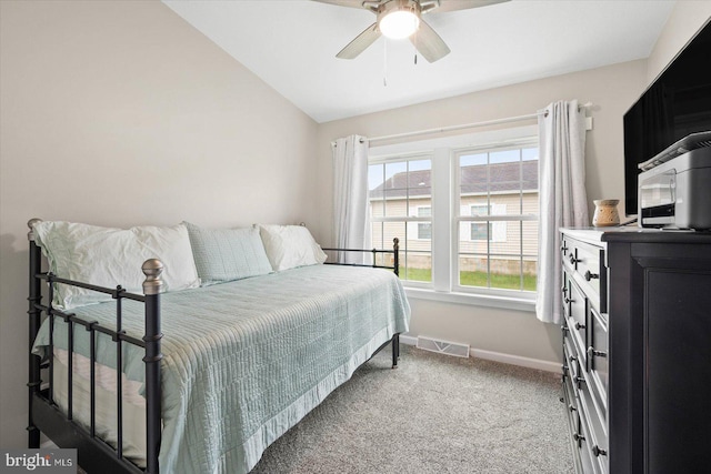 carpeted bedroom with vaulted ceiling and ceiling fan