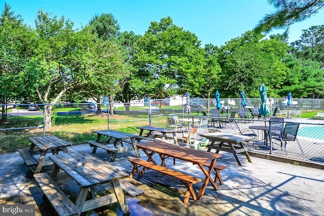 view of property's community featuring a patio area and a pool