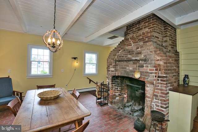 dining area featuring an inviting chandelier, beamed ceiling, a fireplace, and plenty of natural light