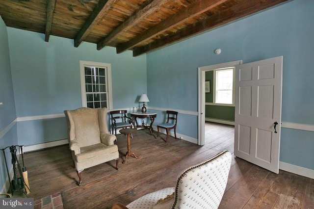 living area with wood ceiling, dark wood-type flooring, beamed ceiling, and a baseboard radiator