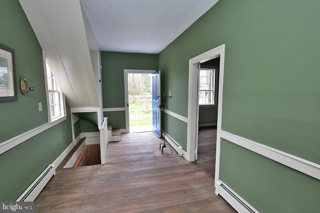 hallway with baseboard heating and hardwood / wood-style floors