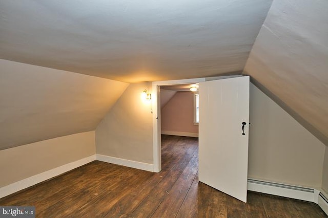 bonus room with lofted ceiling, dark hardwood / wood-style floors, and a baseboard heating unit