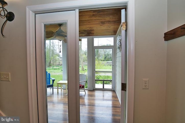 doorway to outside featuring light hardwood / wood-style floors and wooden ceiling