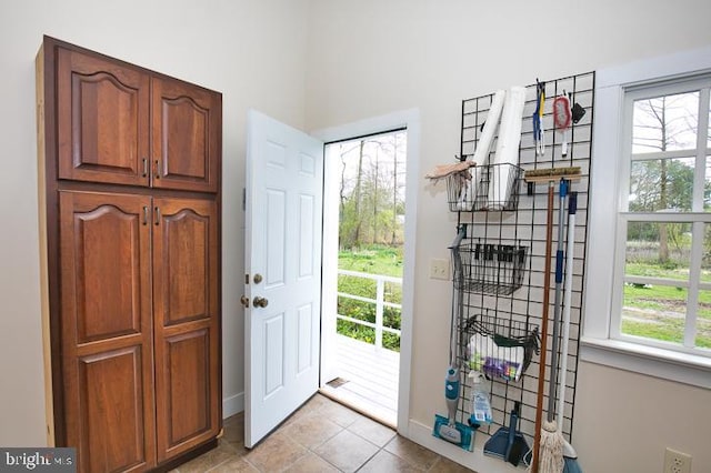 foyer entrance with light tile patterned floors