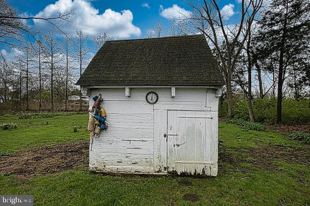 view of outdoor structure with a lawn