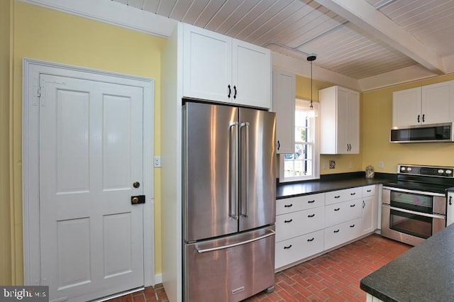 kitchen with beamed ceiling, white cabinets, appliances with stainless steel finishes, decorative light fixtures, and wooden ceiling