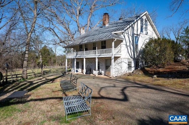 rear view of house featuring a balcony