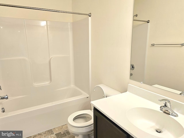 bathroom featuring washtub / shower combination, vanity, and toilet