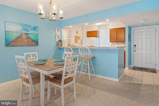 carpeted dining area featuring a notable chandelier