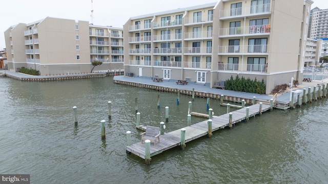 view of dock featuring a water view and a balcony