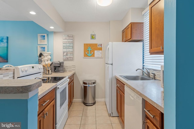 kitchen featuring sink, a textured ceiling, white appliances, and light tile patterned floors