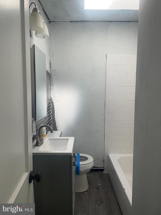 full bathroom featuring vanity, hardwood / wood-style floors, toilet, and shower / washtub combination