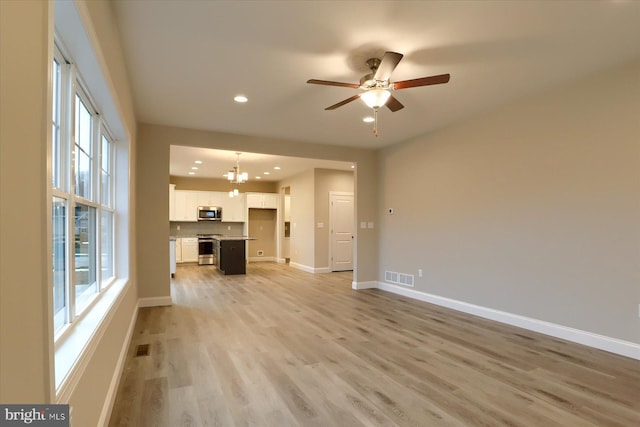 unfurnished living room featuring light wood-style floors, recessed lighting, visible vents, and baseboards