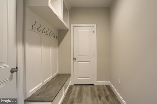 mudroom featuring wood finished floors and baseboards