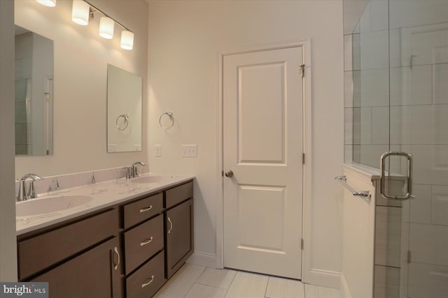 bathroom featuring a sink, a shower stall, and double vanity