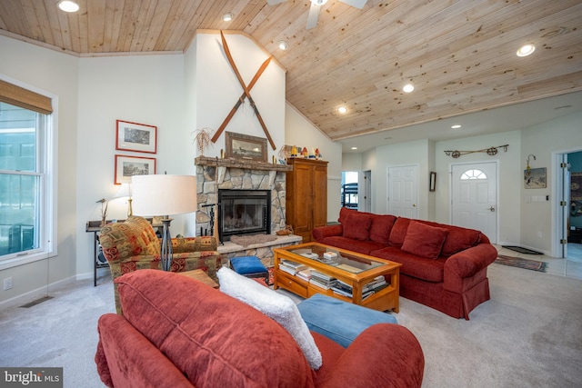 carpeted living room with a healthy amount of sunlight, wooden ceiling, ceiling fan, and a fireplace