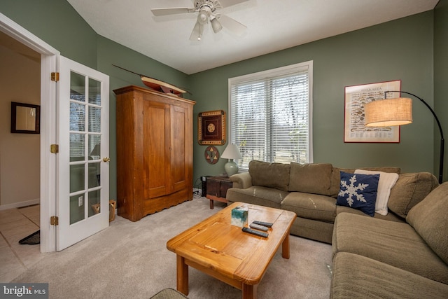 carpeted living room with french doors and ceiling fan