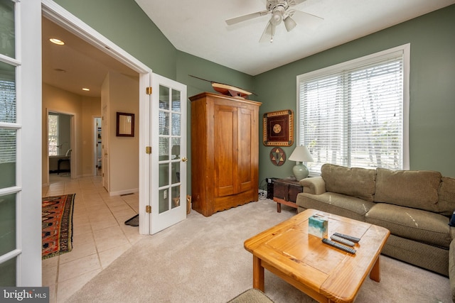 living room featuring french doors, ceiling fan, and light tile flooring