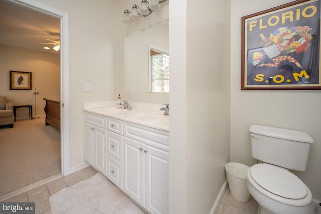 bathroom with tile flooring, double vanity, ceiling fan, and toilet