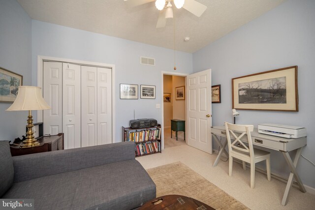 living room with ceiling fan and light colored carpet