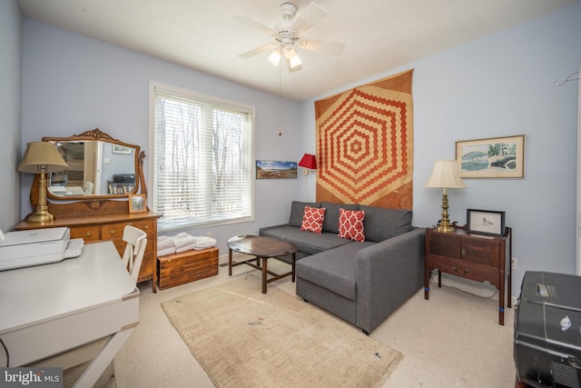 sitting room featuring ceiling fan and light colored carpet