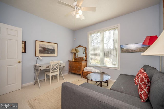 carpeted living room with ceiling fan