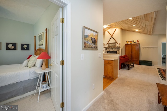 interior space featuring light carpet and wood ceiling