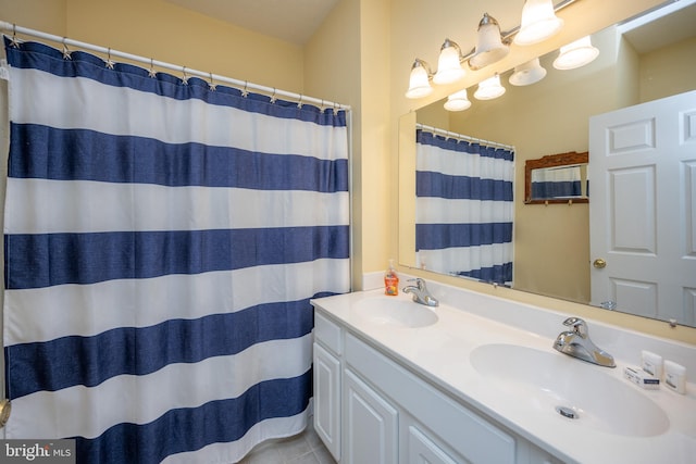 bathroom with double vanity and tile flooring