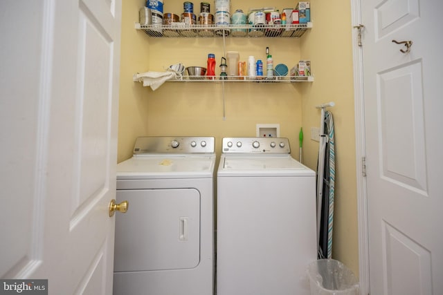 clothes washing area with washer hookup and washing machine and clothes dryer