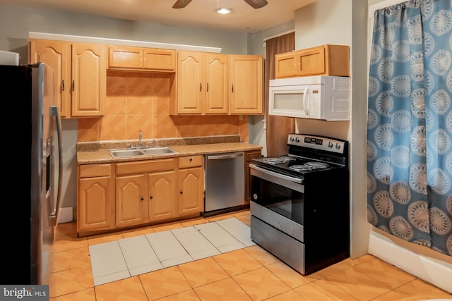 kitchen with ceiling fan, appliances with stainless steel finishes, sink, and light brown cabinets