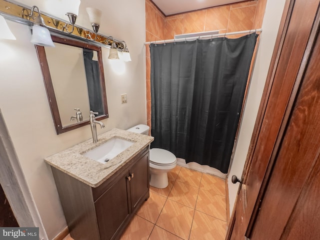 bathroom featuring a shower with curtain, vanity, toilet, and tile patterned flooring