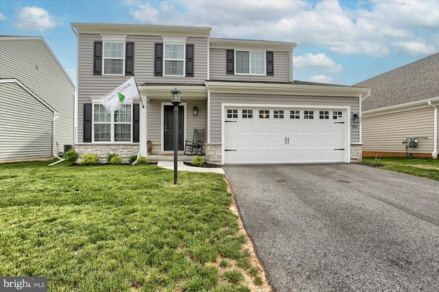 view of front facade with a garage and a front lawn