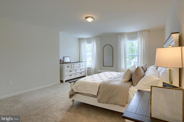 carpeted bedroom featuring multiple windows