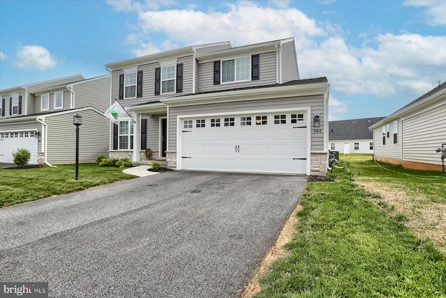 view of front of house featuring a garage and a front yard