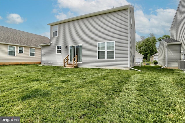 rear view of house with a yard