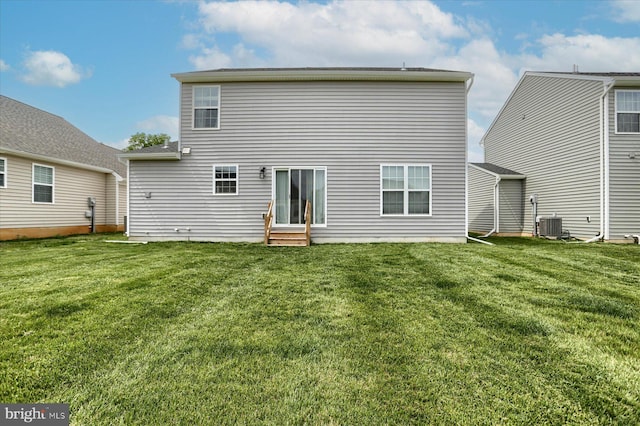 back of property featuring a yard and cooling unit